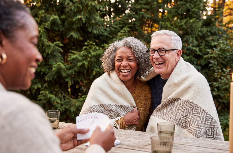 people playing cards outside in a beautiful forrest setting people playing cards outside in a beautiful forrest setting